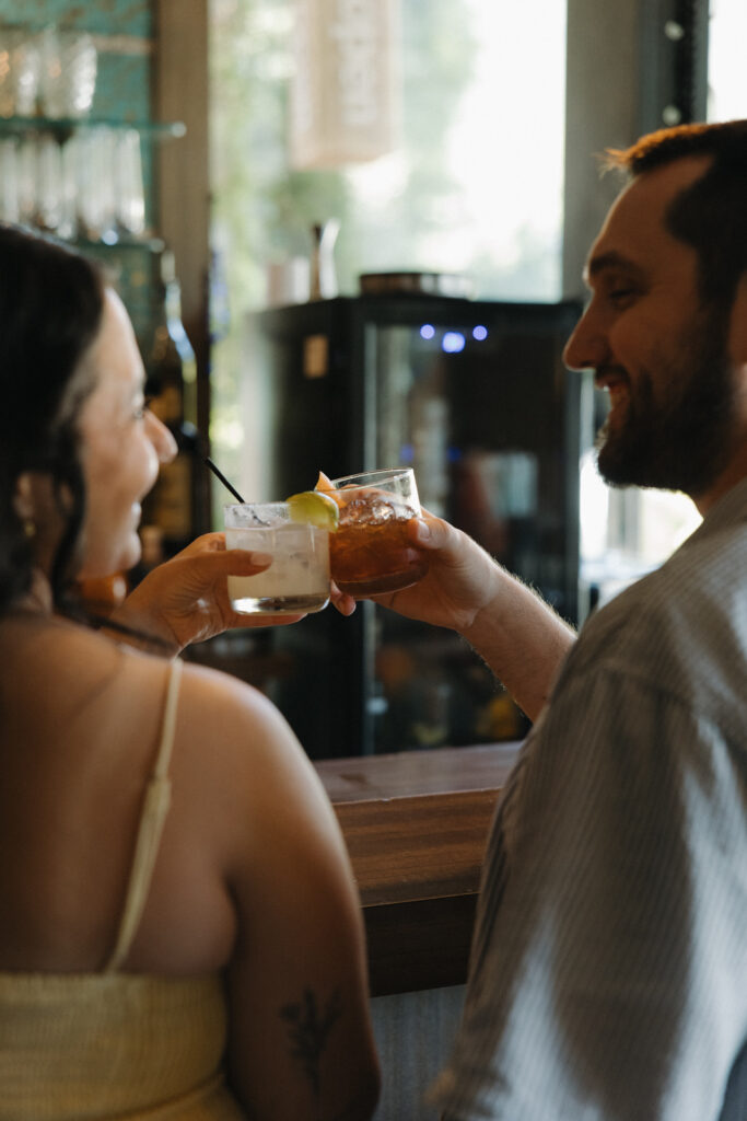 couple having a drink during their engagement session 