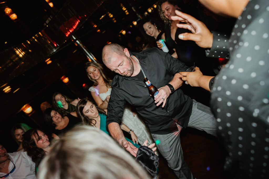 Family dancing at a dinner cruise wedding rehearsal. 