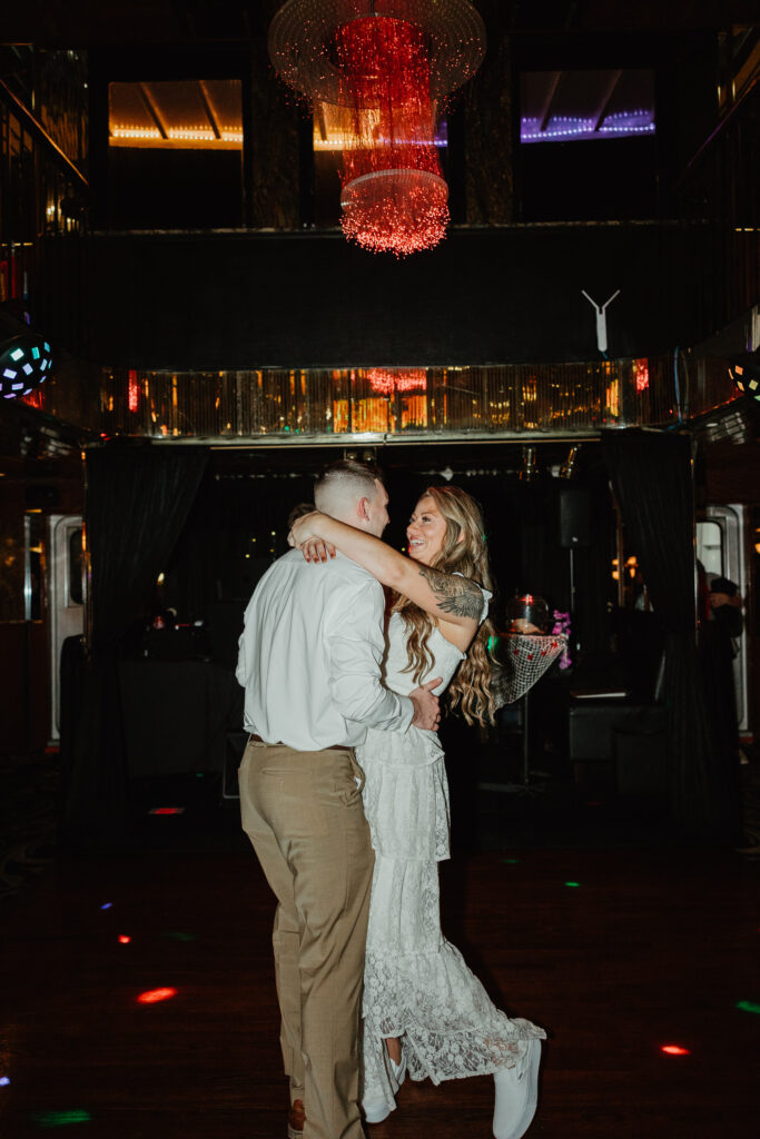 The bride and groom are intimately dancing at their wedding rehearsal dinner the night before their wedding day. 