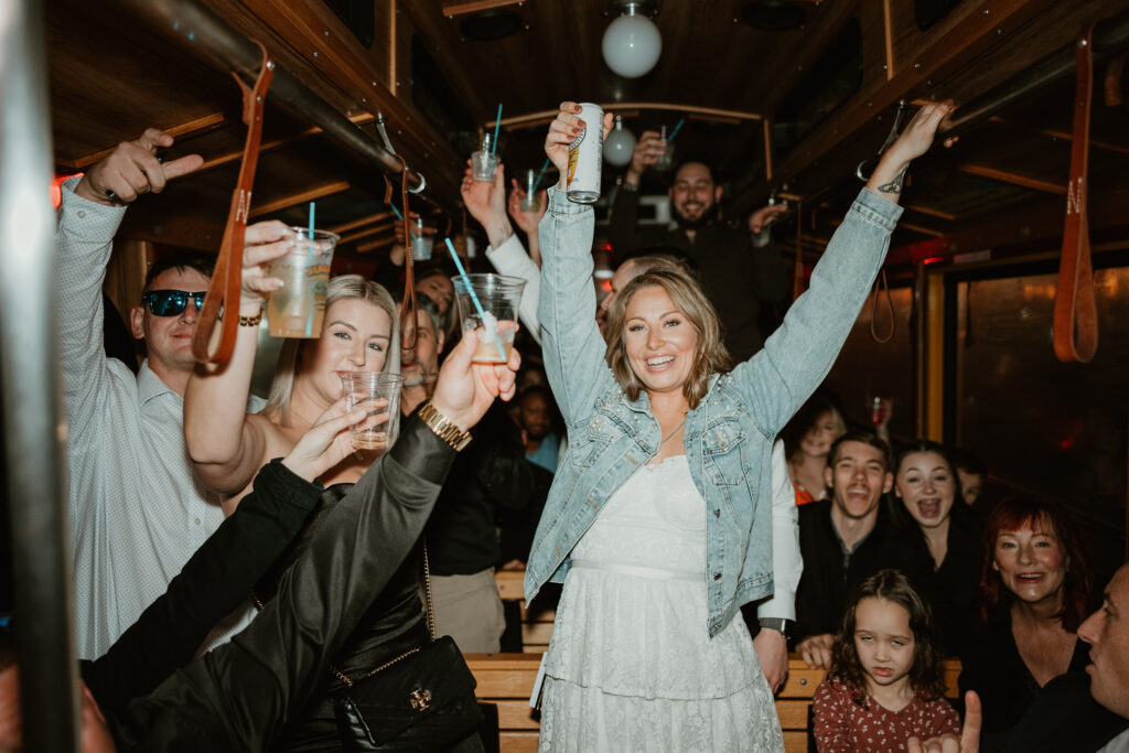 The bride and her wedding party are celebrating at their wedding rehearsal dinner.  