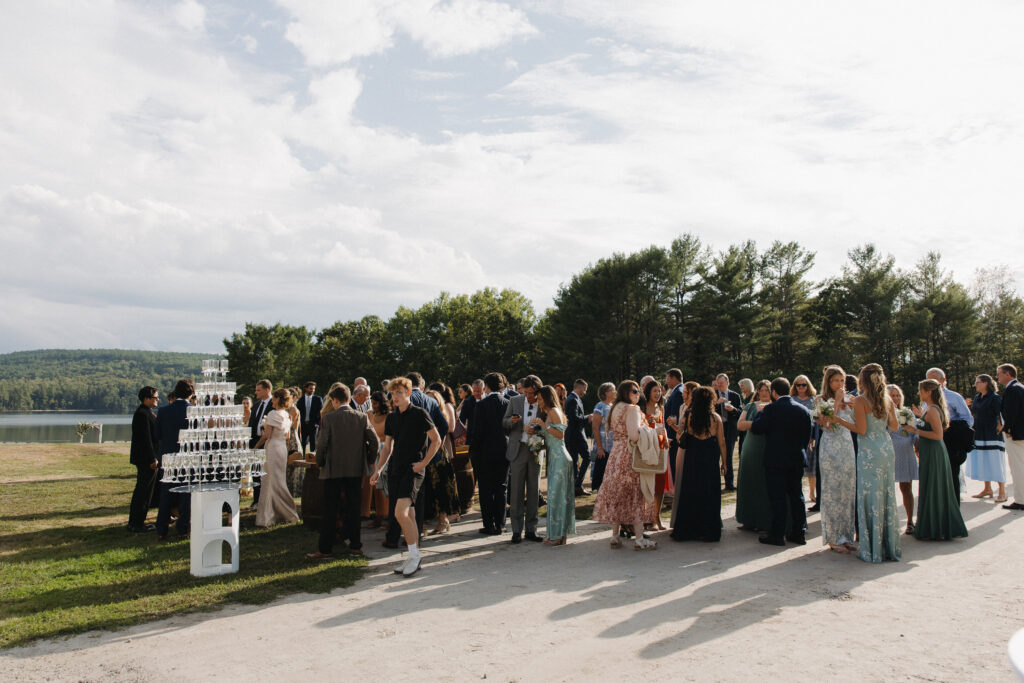 Golden hour cocktail hour at an outdoor wedding venue on a lake 