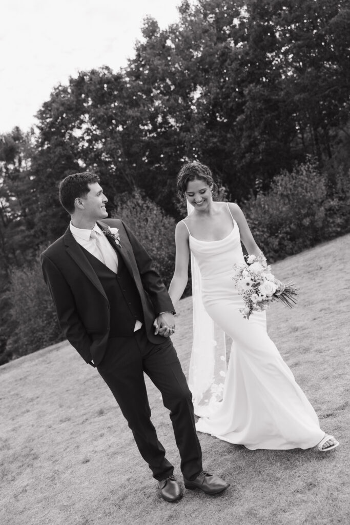 Documentary style photo of a bride and groom walking to their reception after getting married 