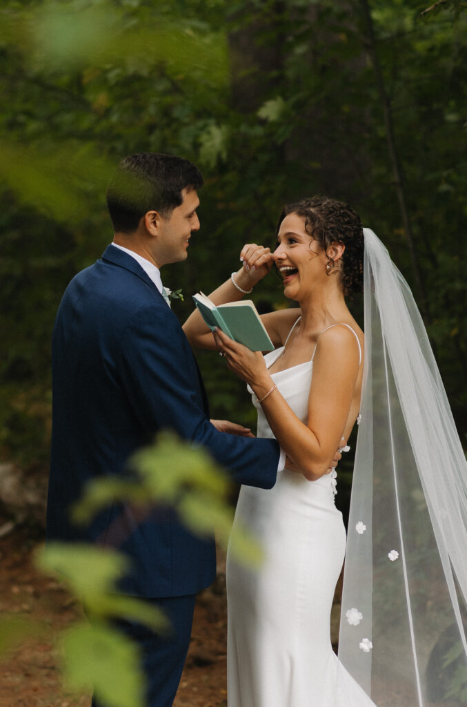 bride whipping a tear away while saying her private vows to her soon to be husband in the forest in connecticut 